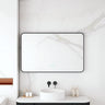 Maia 1200x750mm rectangular motion sensor LED mirror with matte black frame in a bathroom above a round basin