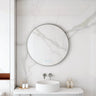 Maia 600mm round motion sensor LED mirror with gun metal frame in a bathroom above a round basin