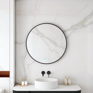 Maia 600mm round motion sensor LED mirror with matte black frame in a bathroom above a round basin