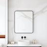 Maia 600x750mm rectangular motion sensor LED mirror with matte black frame in a bathroom above a round basin