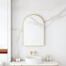 Maia 600x900mm arch motion sensor LED mirror with brushed gold frame in a bathroom above a round basin