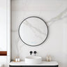 Maia 750mm round motion sensor LED mirror with matte black frame in a bathroom above a round basin