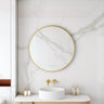 Maia 900mm round motion sensor LED mirror with brushed gold frame in a bathroom above a round basin