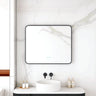Maia 900x750mm rectangular motion sensor LED mirror with matte black frame in a bathroom above a round basin