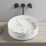 Olley 395mm round above counter basin in matte Carrara white marble look with a wall mounted mixer