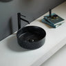 Ollia 360mm round above counter basin in matte black marble look on a white bathroom bench