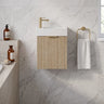 Scandinavia 450mm Classic Oak Fluted Wall Hung Vanity with poly marble basin top and brushed gold handle in a marble powder room - RJ Bathroom