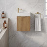 Scandinavia 450mm Prime Oak Fluted Wall Hung Vanity with poly marble basin top and brushed gold handle in a marble powder room - RJ Bathroom