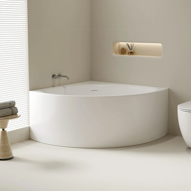 Stanford 1200mm triangle corner bath in gloss white installed in a bathroom corner