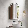 Venus 600x900mm arch front-lit motion sensor LED mirror with matte black frame in a bathroom above a round basin