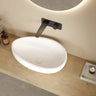 Waverton 600mm solid surface stone oval above counter basin in matte white on a timber bench